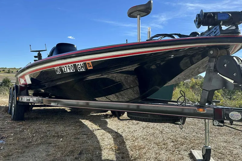 Slide: The Image of 2003 Skeeter ZX200 boat on trailer, parked outdoors under clear blue sky. - 5