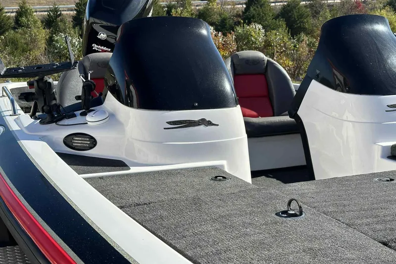 Slide: The Image of 2003 Skeeter ZX200 boat interior with dual consoles and seating, surrounded by lush greenery. - 9