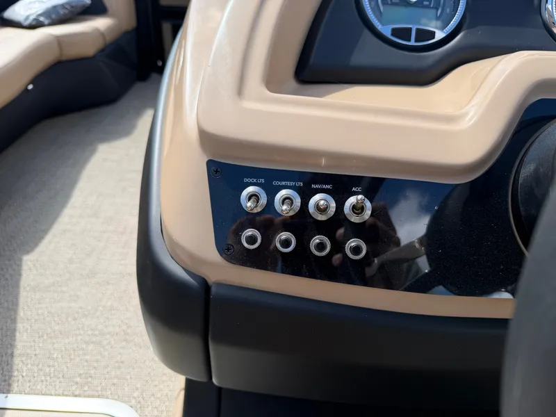Slide: The Image of Close-up of a Barletta CABRIO 22 UC boat dashboard with multiple switches. - 38