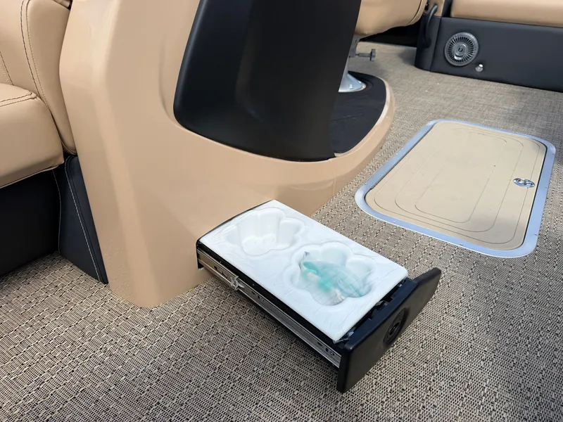 Slide: The Image of A pull-out cup holder in a Barletta CABRIO 22 UC boat, surrounded by beige interior. - 30