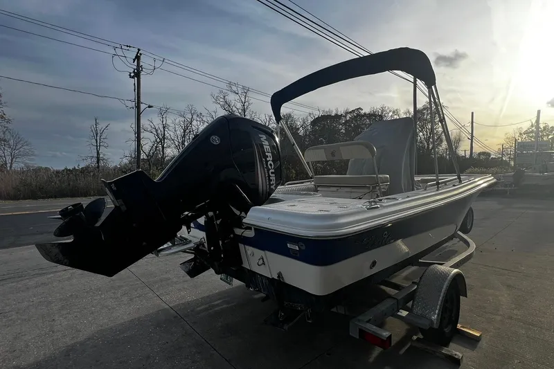 Slide: The Image of 2016 Carolina Skiff EV218 Sea Skiff on trailer, featuring Mercury outboard motor. - 3