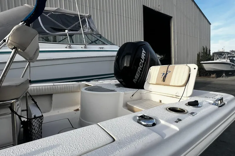 Slide: The Image of 2016 Carolina Skiff EV218 Sea Skiff with Mercury engine, docked near a warehouse. - 7