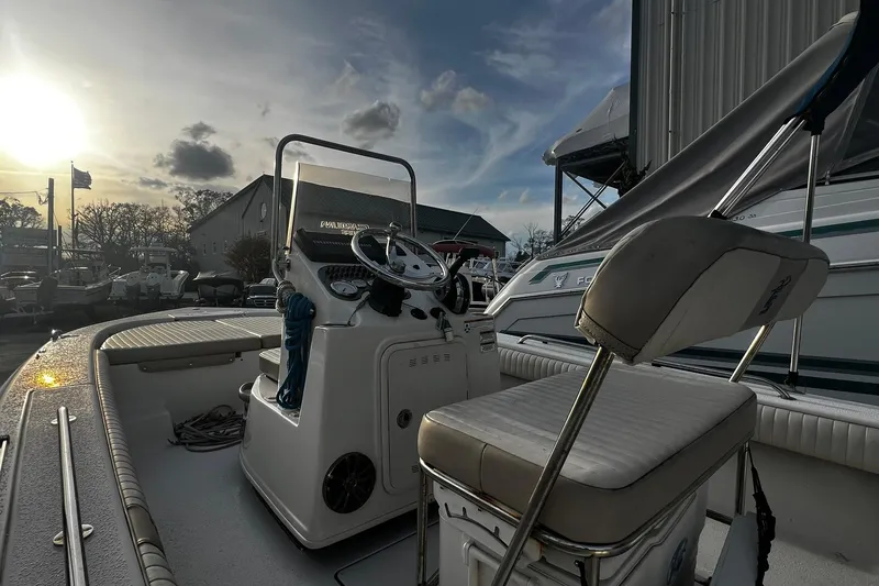 Slide: The Image of 2016 Carolina Skiff EV218 Sea Skiff interior with steering console at sunset. - 8
