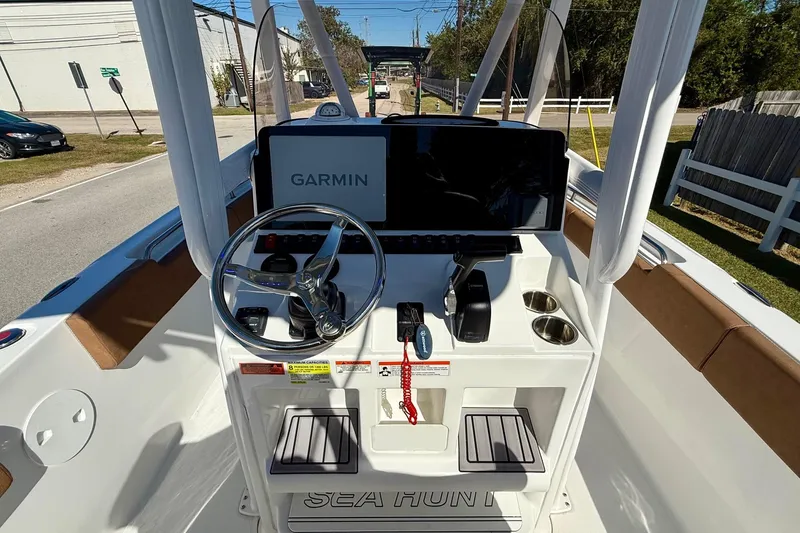 Slide: The Image of 2023 Sea Hunt Ultra 234 boat dashboard with Garmin navigation system and steering wheel. - 10