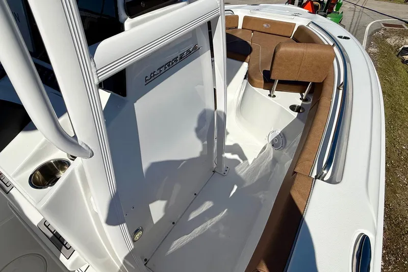 Slide: The Image of 2023 Sea Hunt Ultra 234 boat interior with brown seating and white deck. - 15