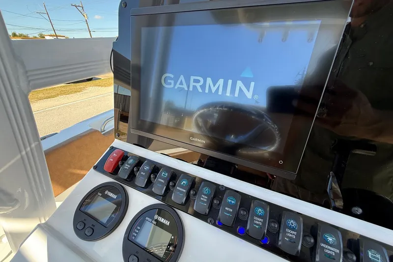 Slide: The Image of Control panel of 2023 Sea Hunt Ultra 234 with Garmin display and Yamaha gauges. - 17