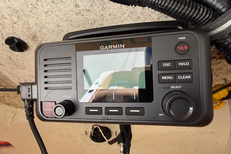 Slide: The Image of Garmin marine radio on 2023 Sea Hunt Ultra 234 boat dashboard. - 19