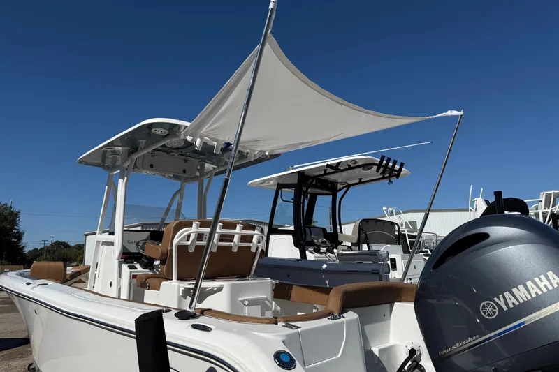 Slide: The Image of 2023 Sea Hunt Ultra 234 boat with Yamaha engine, featuring a sunshade and modern design. - 21