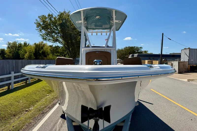 Slide: The Image of 2023 Sea Hunt Ultra 234 boat on trailer, sunny day, street view. - 6