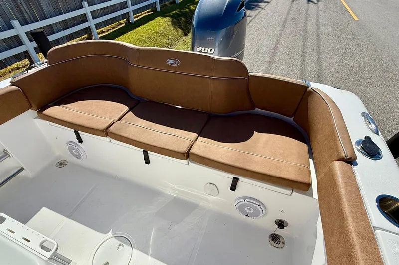 Slide: The Image of 2023 Sea Hunt Ultra 234 boat with brown cushioned seating and Yamaha 200 engine. - 7