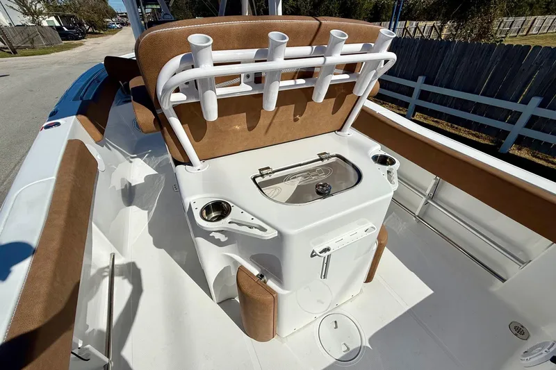 Slide: The Image of 2023 Sea Hunt Ultra 234 boat interior with rod holders and seating. - 8