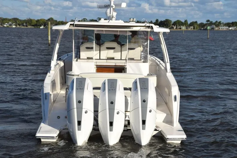 Slide: The Image of Extended platforms outboard of motors - nice access. Indicator lights aft are on when engines are running. Swim ladder folds out on portside. - 43