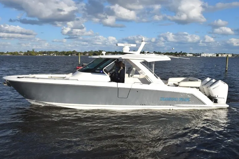 Slide: The Image of FLIR camera mounted on top of mast and easily operated through the Garmin display. LED remote control spotlight forward on hardtop. - 47