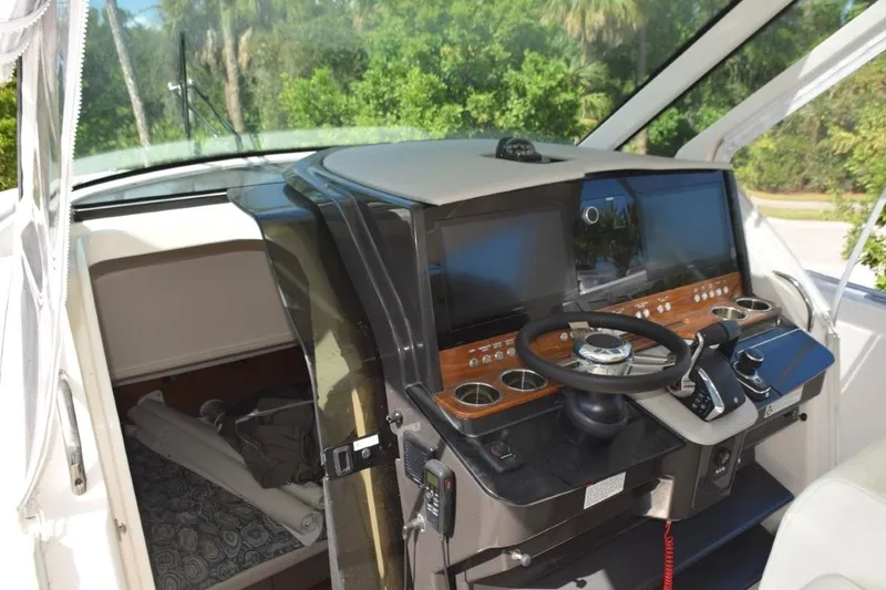 Slide: The Image of 2024 Tiara Yachts 38 LS helm with dual Garmin 8616 Nav screens, bow thruster, Fusion stereo. RGB lighting control - 7