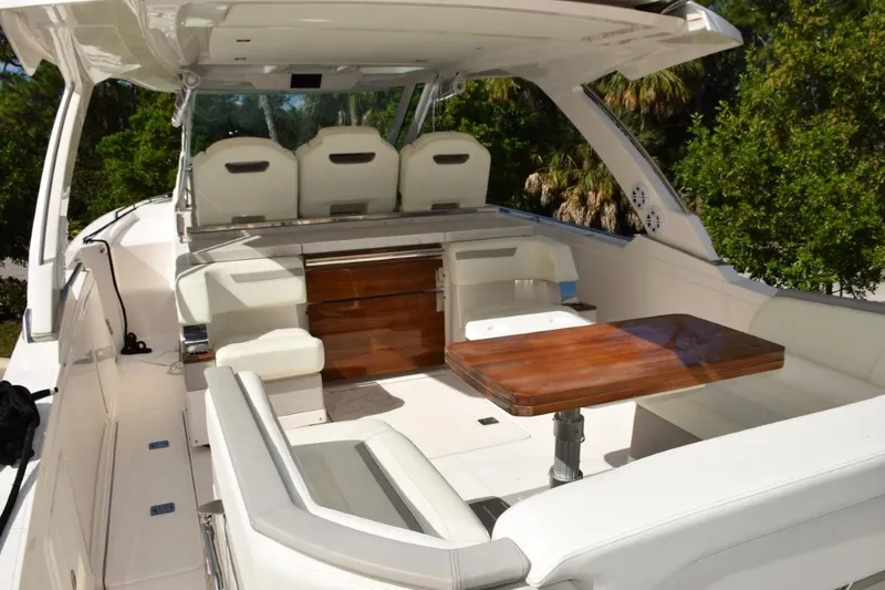 Slide: The Image of 2024 Tiara Yachts 38 LS opening skylights overhead of helm. Engine data screen in overhead panel. - 8