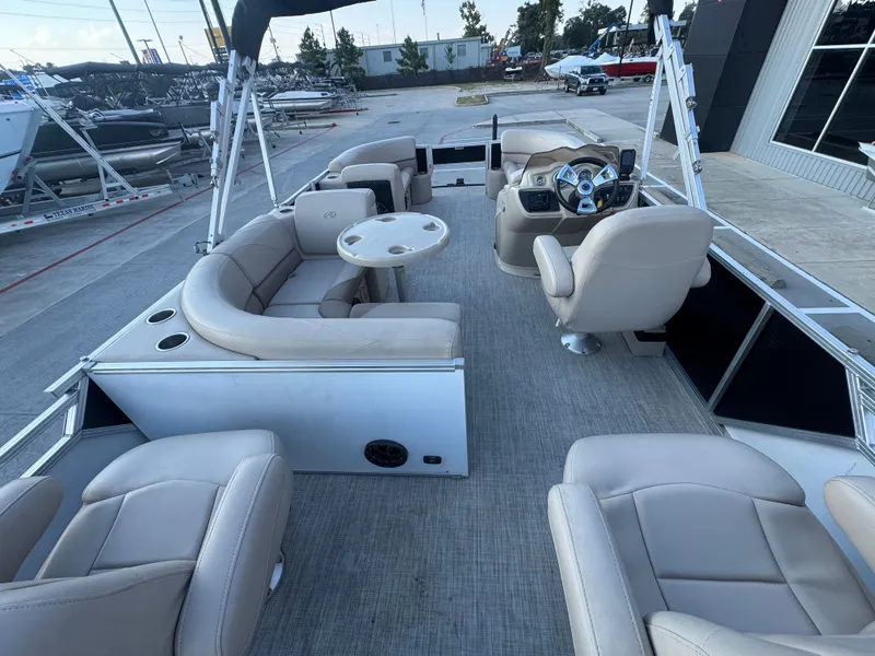 Slide: The Image of 2017 Avalon LSZ rf 2285 pontoon boat interior with beige seating and steering console. - 29