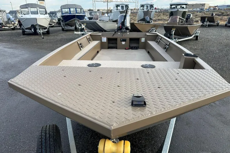 Slide: The Image of 2024 Smoker Craft Sportsman 1866 boat on trailer, surrounded by other boats. - 2