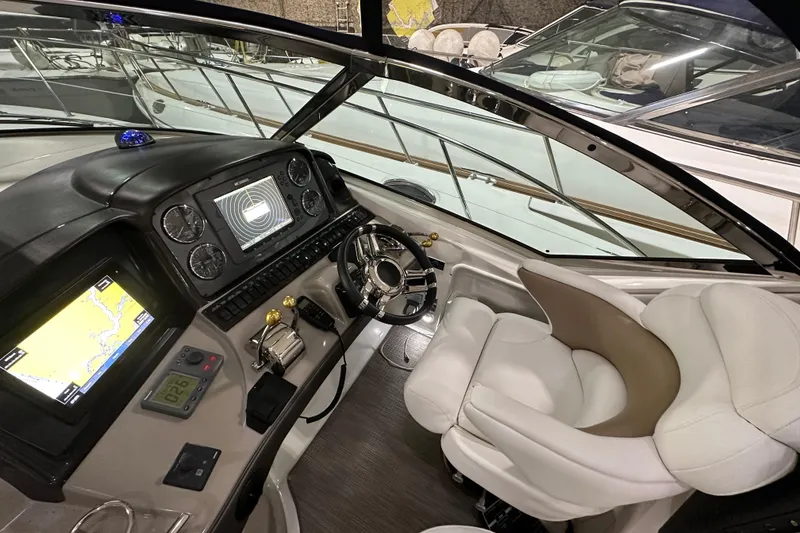 Slide: The Image of 2007 Sea Ray 44 Sundancer helm with navigation display and controls. - 16