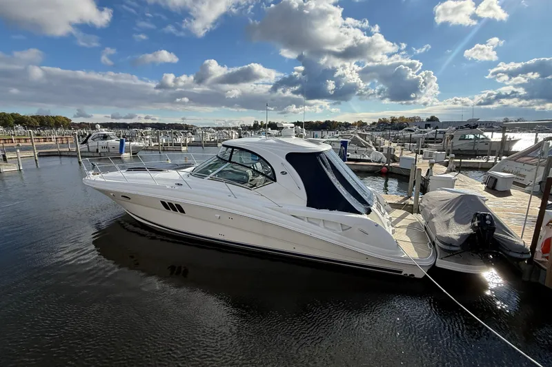 Slide: The Image of 2007 Sea Ray 44 Sundancer docked at marina, rear view with cover. - 3