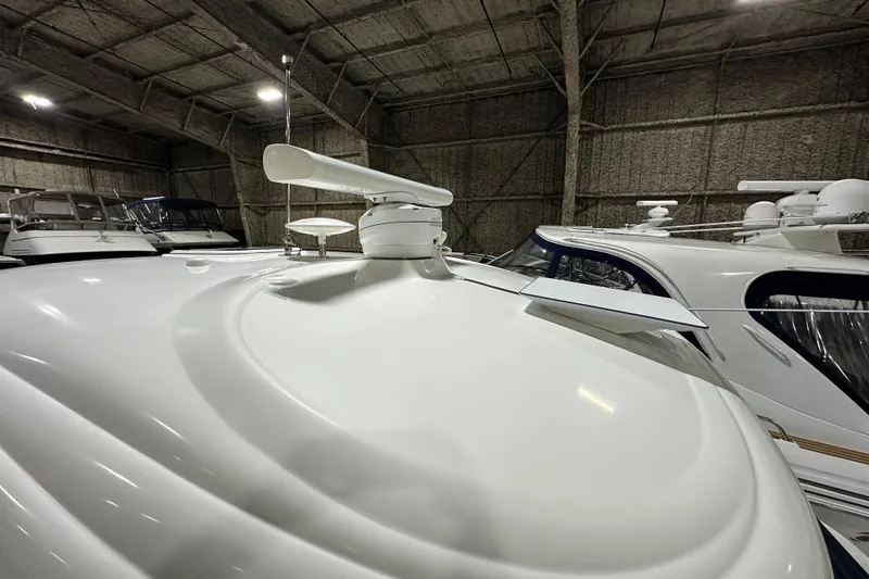 Slide: The Image of 2007 Sea Ray 44 Sundancer yacht in storage, showcasing sleek design and radar equipment. - 32
