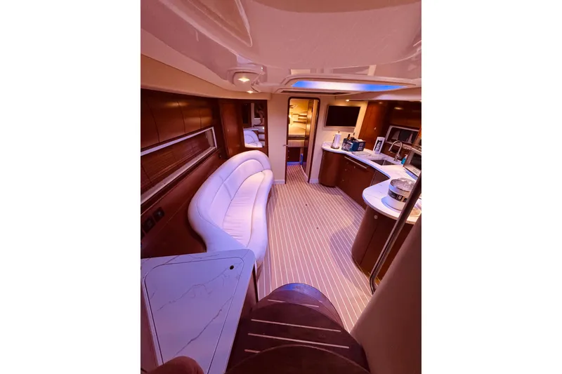 Slide: The Image of Luxurious 2007 Sea Ray 44 Sundancer yacht interior with white seating and nautical-themed rug. - 6