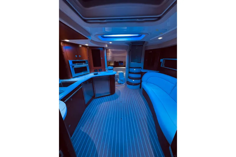 Slide: The Image of Luxurious 2007 Sea Ray 44 Sundancer yacht interior with white seating and anchor-themed rug. - 7