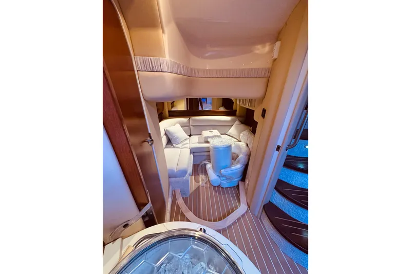 Slide: The Image of Interior of 2007 Sea Ray 44 Sundancer yacht with white seating and mounted TV. - 9