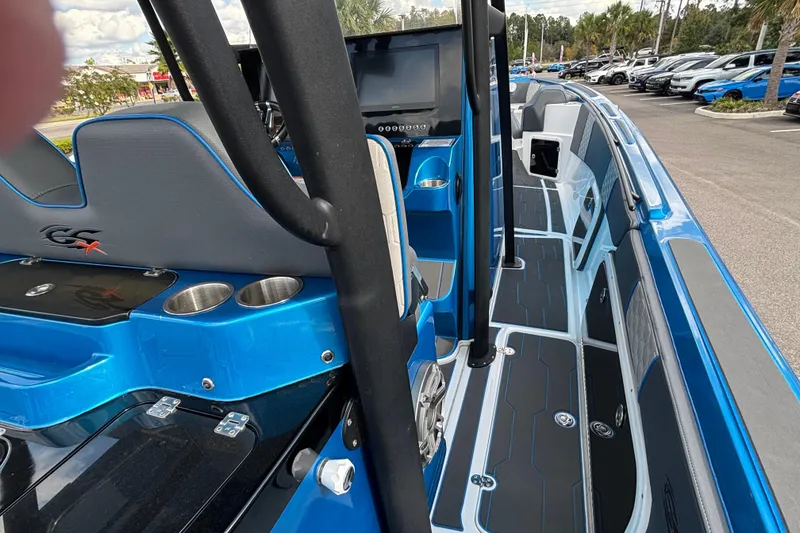 Slide: The Image of 2024 GSX 36 boat interior with blue accents, modern seating, and cup holders. - 31