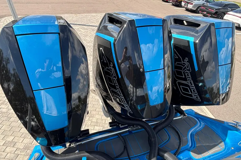 Slide: The Image of Triple blue and black outboard motors on a 2024 GSX 36 boat. - 4