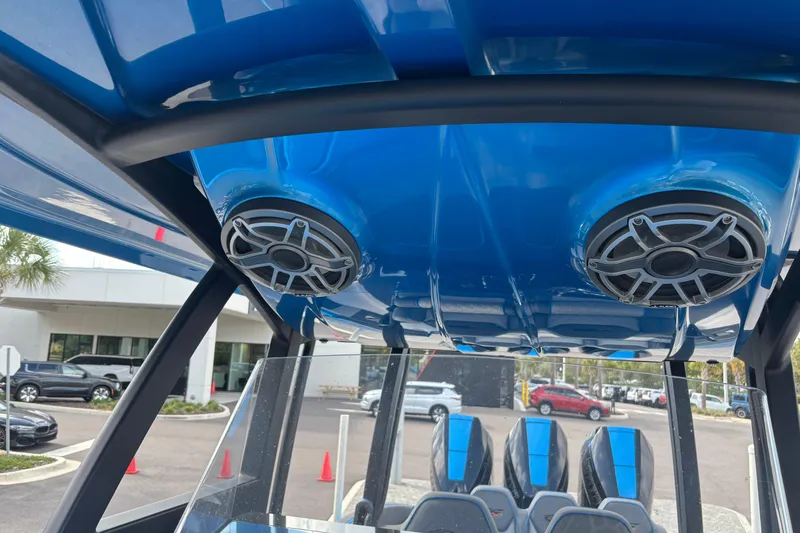 Slide: The Image of 2024 GSX 36 boat interior with blue canopy and mounted speakers. - 10