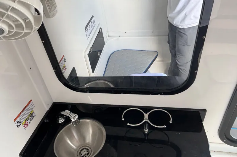 Slide: The Image of 2024 GSX 36 interior with sink, mirror, and storage compartment. - 14