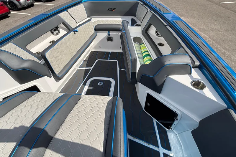 Slide: The Image of 2024 GSX 36 boat interior with gray and blue seating, modern design, and storage compartments. - 22