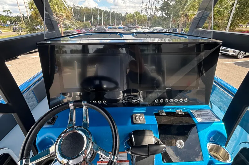 Slide: The Image of 2024 GSX 36 boat dashboard with steering wheel and dual screens. - 25