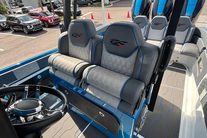Slide: The Image of 2024 GSX 36 boat interior with stylish seating and modern steering wheel design. - 33