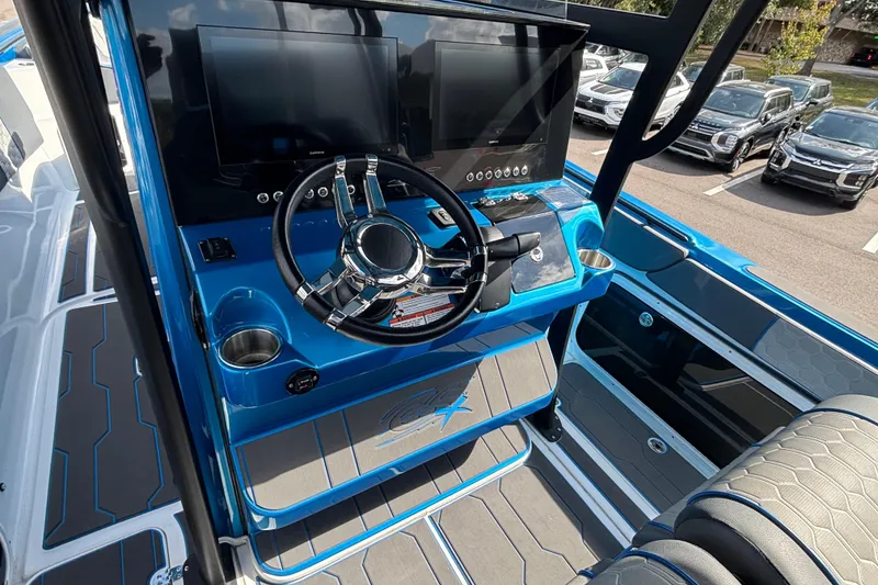 Slide: The Image of 2024 GSX 36 boat dashboard with dual screens and modern steering wheel. - 34