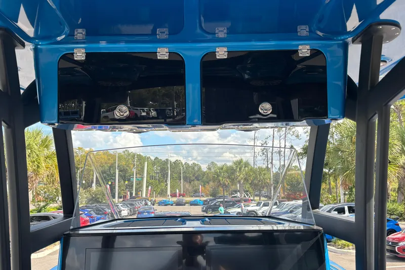 Slide: The Image of 2024 GSX 36 boat interior with blue overhead compartments and scenic outdoor view. - 38