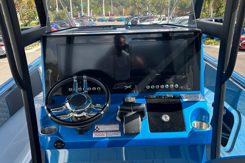 Slide: The Image of 2024 GSX 36 boat dashboard with steering wheel and digital displays. - 39