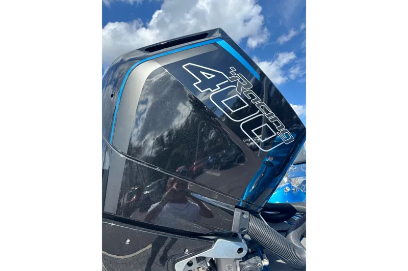 Slide: The Image of 2024 GSX 36 outboard motor, black with blue accents, under a clear sky. - 40