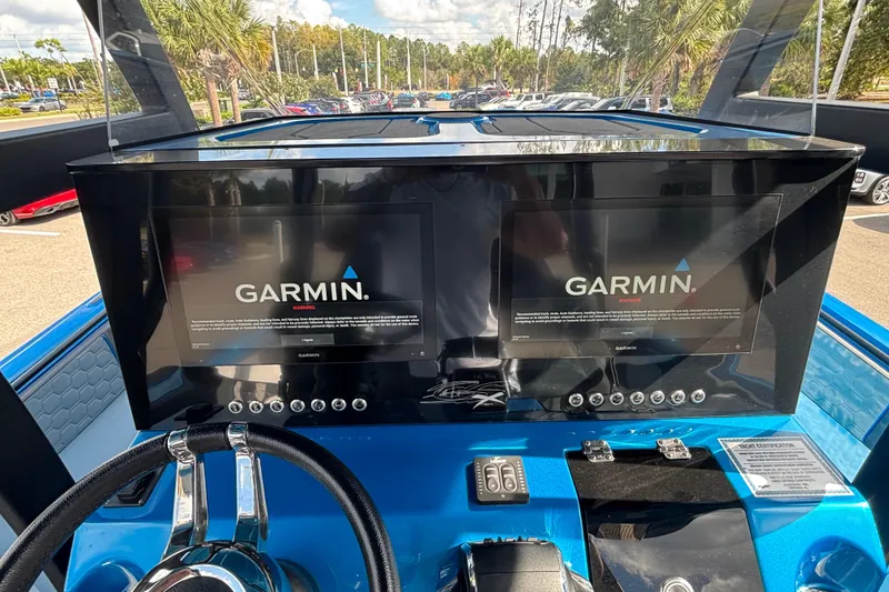 Slide: The Image of 2024 GSX 36 boat dashboard with dual Garmin displays and steering wheel. - 6