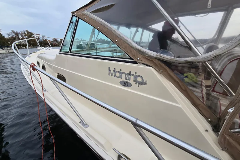 Slide: The Image of 2001 Mainship 30 Pilot Rum Runner boat detail with water reflection. - 10