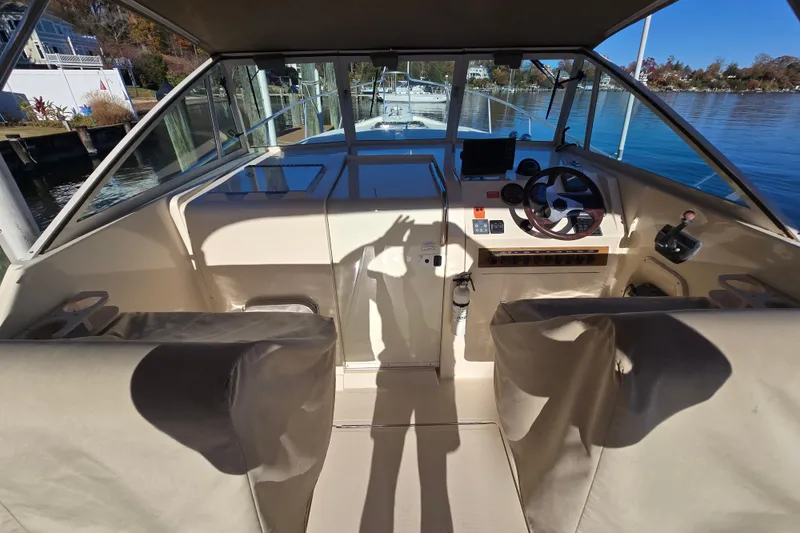 Slide: The Image of Open refrigerator inside 2001 Mainship 30 Pilot Rum Runner boat, wooden cabinetry visible. - 27