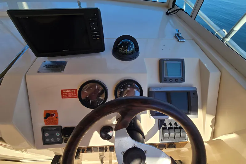 Slide: The Image of 2001 Mainship 30 Pilot Rum Runner interior with wood flooring and seating area. - 29