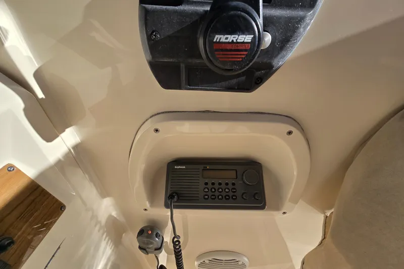 Slide: The Image of Cozy cabin interior of 2001 Mainship 30 Pilot Rum Runner with striped cushions and decorative pillows. - 30