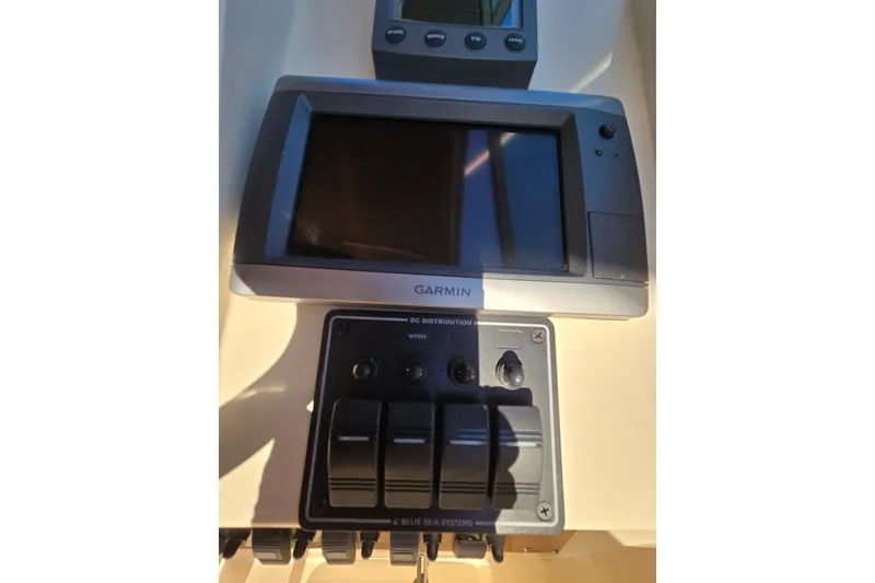 Slide: The Image of Cozy cabin interior of 2001 Mainship 30 Pilot Rum Runner with striped cushions and colorful pillows. - 31