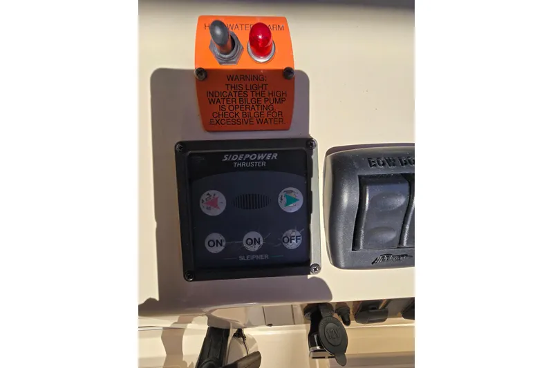 Slide: The Image of 2001 Mainship 30 Pilot Rum Runner cabin with striped bedding and wooden table. - 32