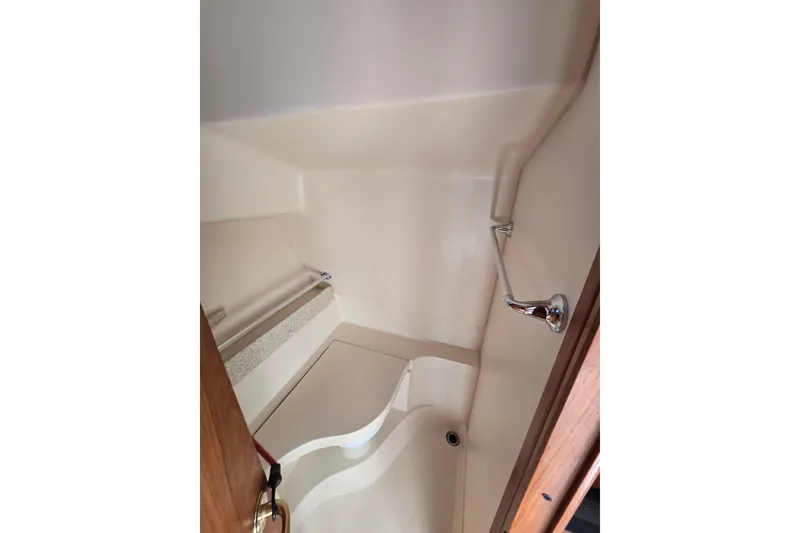 Slide: The Image of 2001 Mainship 30 Pilot Rum Runner boat propeller and hull on gravel surface. - 43