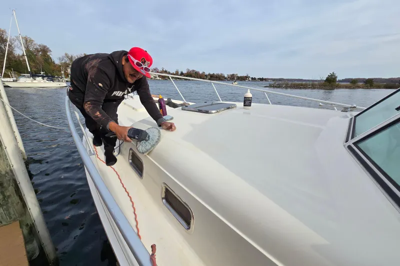 Slide: The Image of 2001 Mainship 30 PILOT boat interior with striped seating and helm area. - 6