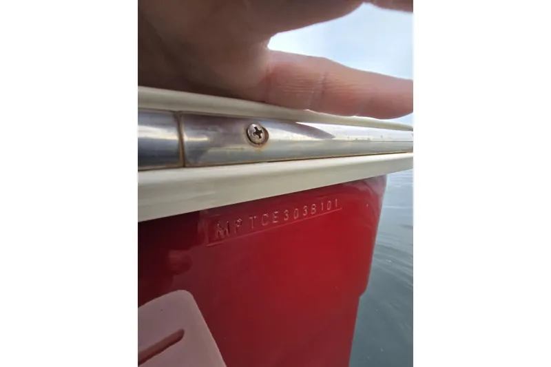 Slide: The Image of 2001 Mainship 30 Pilot Rum Runner boat docked on a serene lake with autumn trees. - 7