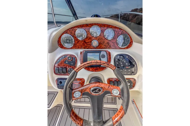 Slide: The Image of 2007 Sea Ray 290 Sun Sport dashboard with wood accents and modern controls. - 11