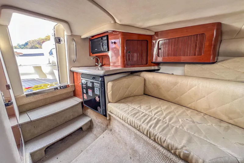 Slide: The Image of Interior of 2007 Sea Ray 290 Sun Sport boat with kitchenette and seating area. - 13